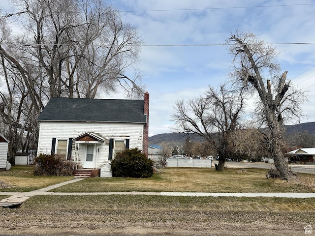 view of front of house featuring a chimney and a mountain view