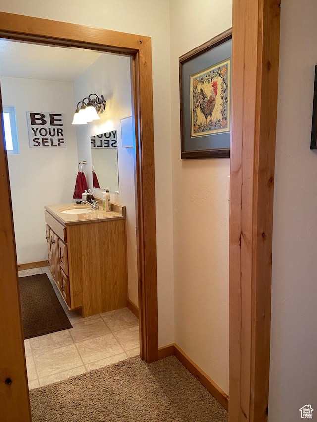 bathroom with vanity and baseboards