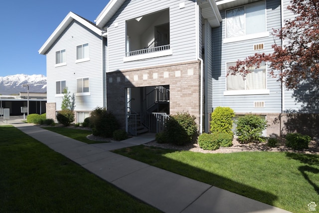 view of front of property with a front yard and brick siding