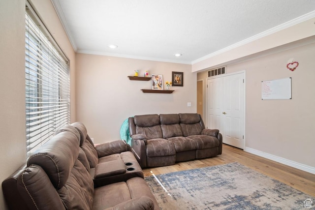 living room with wood finished floors, baseboards, crown molding, and recessed lighting