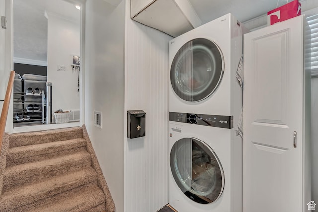 laundry room featuring stacked washer and clothes dryer