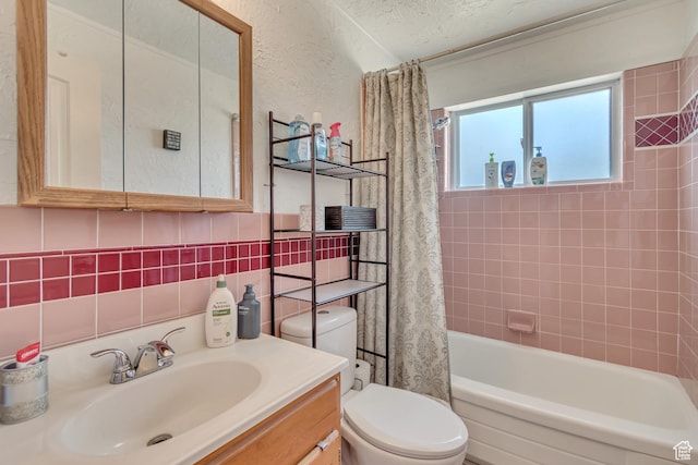 bathroom featuring toilet, shower / tub combo with curtain, vanity, and tile walls
