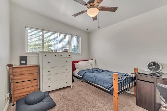 bedroom featuring light carpet, lofted ceiling, and ceiling fan