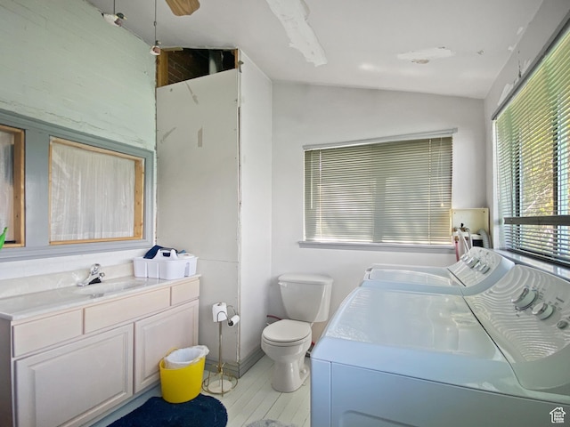 244 S Main St W, Ephraim, UT 84627 - bathroom with washer and clothes dryer, vaulted ceiling, vanity, toilet, and wood finished floors