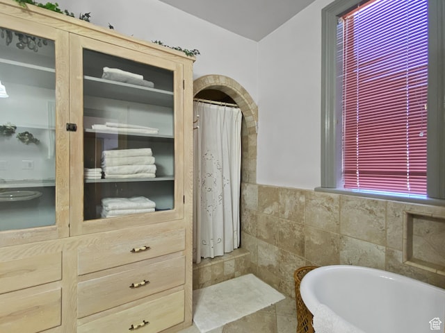 244 S Main St W, Ephraim, UT 84627 - bathroom featuring a tub, tile walls, curtained shower, and plenty of natural light