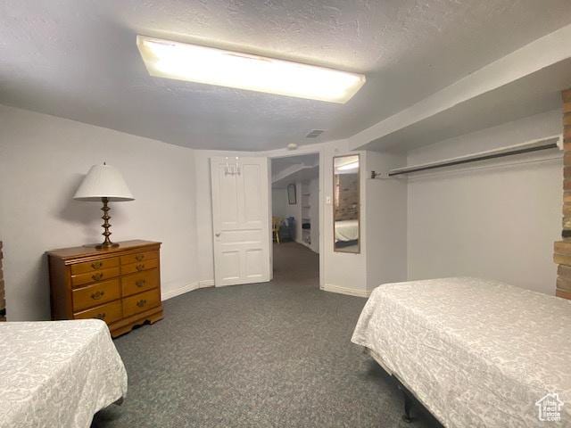 244 S Main St W, Ephraim, UT 84627 - bedroom featuring dark colored carpet, a textured ceiling, and baseboards