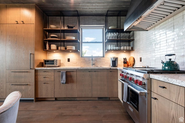kitchen featuring high end range, ventilation hood, a sink, open shelves, and backsplash