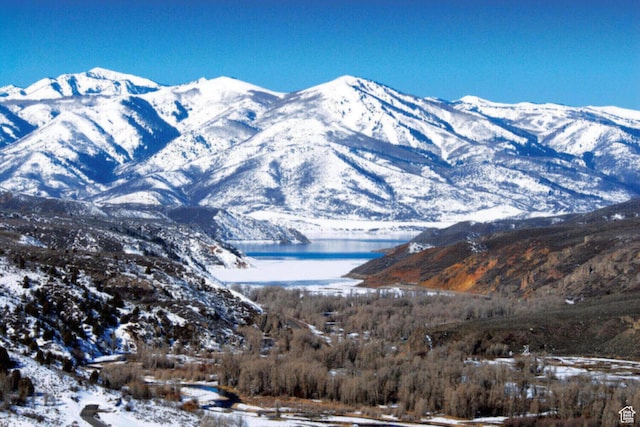 view of mountain backdrop featuring a nearby body of water