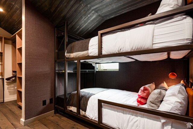 bedroom with lofted ceiling, hardwood / wood-style floors, and wooden ceiling