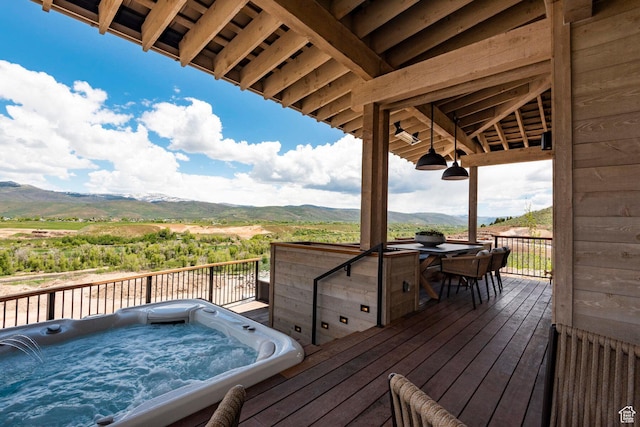 deck featuring a mountain view and an outdoor hot tub