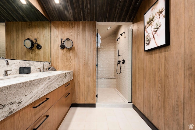 full bath featuring a tile shower, vanity, wooden ceiling, and tile patterned flooring
