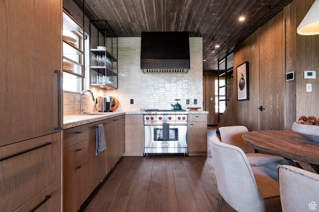 kitchen with a sink, exhaust hood, designer range, dark wood finished floors, and wooden ceiling