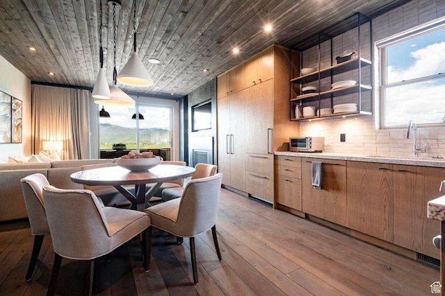 dining area with light wood-style flooring, recessed lighting, and wood ceiling