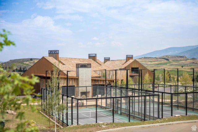view of swimming pool featuring fence and a mountain view