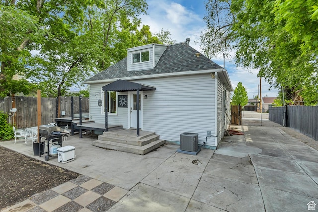 21 E Angelo Ave S, South Salt Lake, UT 84115 - back of house featuring a patio area, cooling unit, a fenced backyard, and a shingled roof