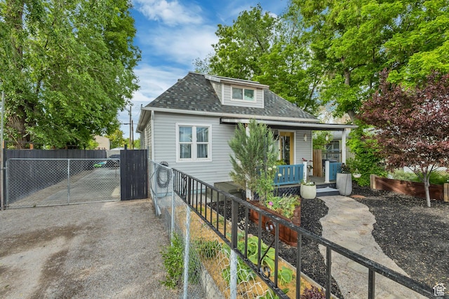21 E Angelo Ave S, South Salt Lake, UT 84115 - bungalow-style home featuring roof with shingles, a porch, fence, and a gate