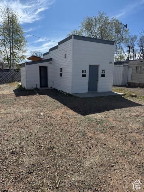 rear view of house with fence