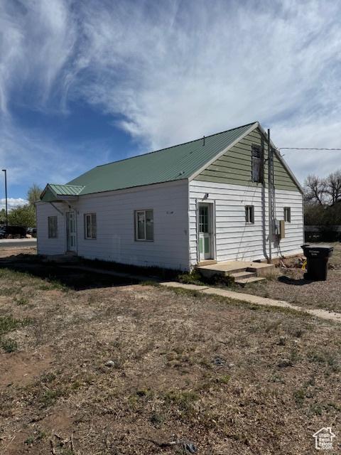 rear view of house featuring metal roof