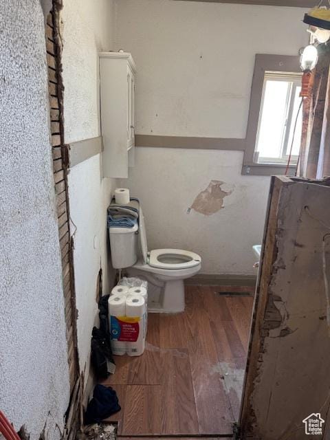 bathroom featuring toilet and wood finished floors