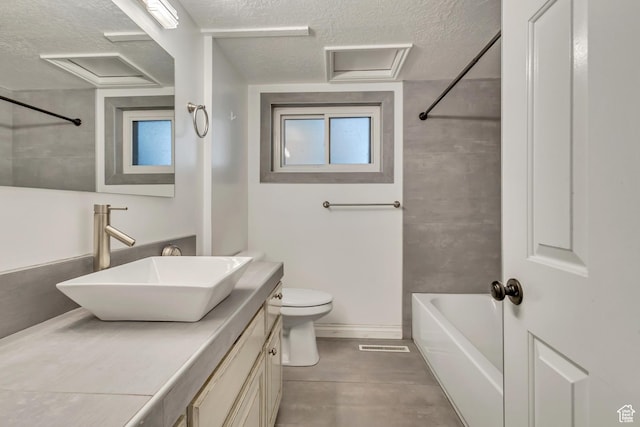 1343 S 200 E, Farmington, UT 84025 - bathroom featuring a textured ceiling, toilet, vanity, and plenty of natural light