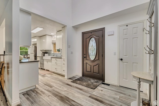 1343 S 200 E, Farmington, UT 84025 - foyer entrance with light wood-style flooring, baseboards, and a high ceiling