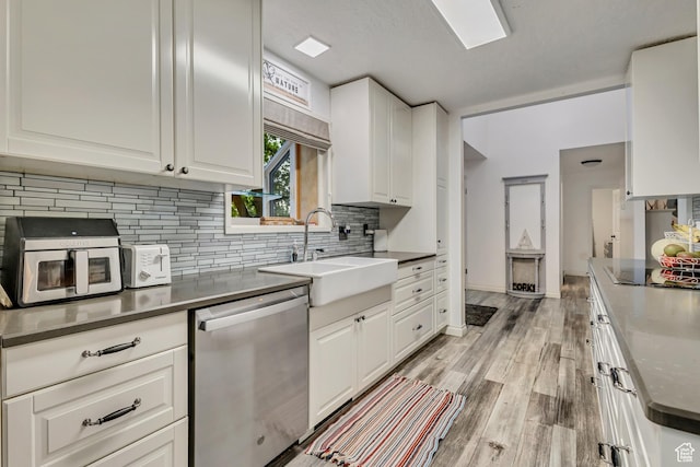 1343 S 200 E, Farmington, UT 84025 - kitchen featuring stainless steel dishwasher, a sink, black electric stovetop, decorative backsplash, and white cabinetry