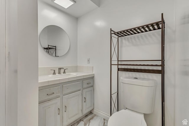 1343 S 200 E, Farmington, UT 84025 - bathroom with marble look tiles, toilet, vanity, and baseboards