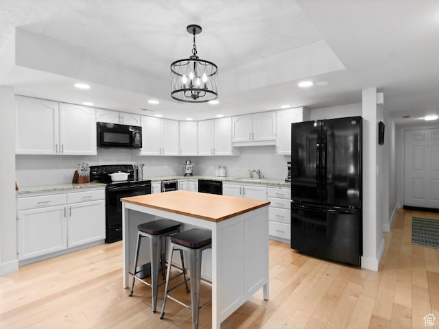 141 E Second Ave N Unit 502, Salt Lake City, UT 84103 - kitchen featuring black appliances, light countertops, recessed lighting, white cabinets, and light wood-type flooring