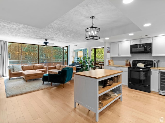 141 E Second Ave N Unit 502, Salt Lake City, UT 84103 - kitchen featuring black appliances, light wood-style flooring, white cabinetry, beverage cooler, and open shelves
