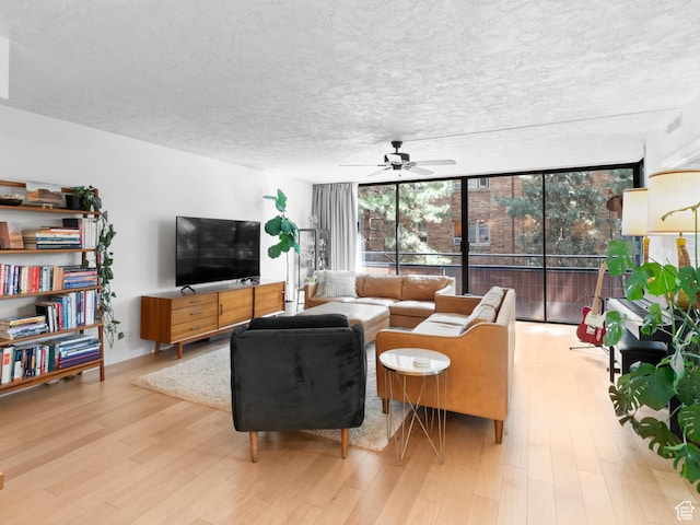 141 E Second Ave N Unit 502, Salt Lake City, UT 84103 - living area featuring expansive windows, ceiling fan, and wood finished floors