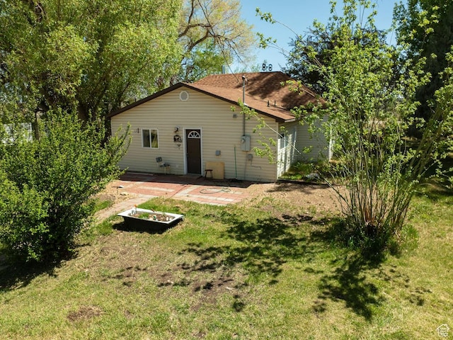 50 S 400 E, Myton, UT 84052 - rear view of house with a lawn and a patio area