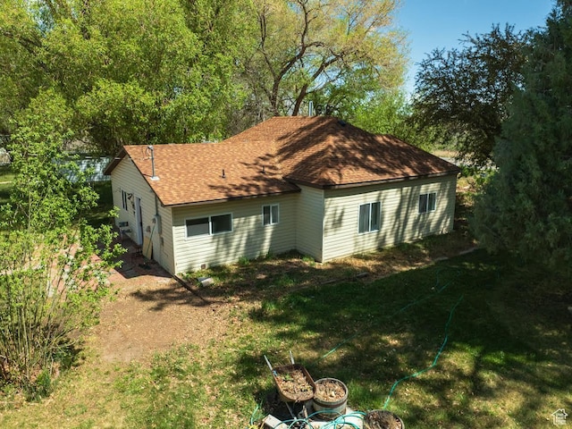 50 S 400 E, Myton, UT 84052 - rear view of house featuring roof with shingles, a lawn, and a fire pit