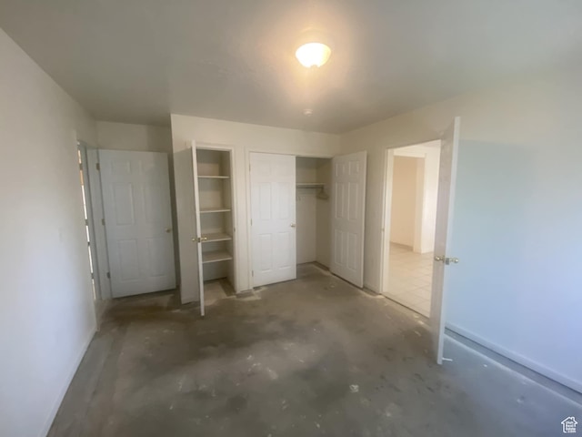 50 S 400 E, Myton, UT 84052 - unfurnished bedroom with concrete flooring and two closets