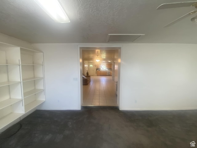 50 S 400 E, Myton, UT 84052 - unfurnished room with attic access, a textured ceiling, dark carpet, a ceiling fan, and baseboards