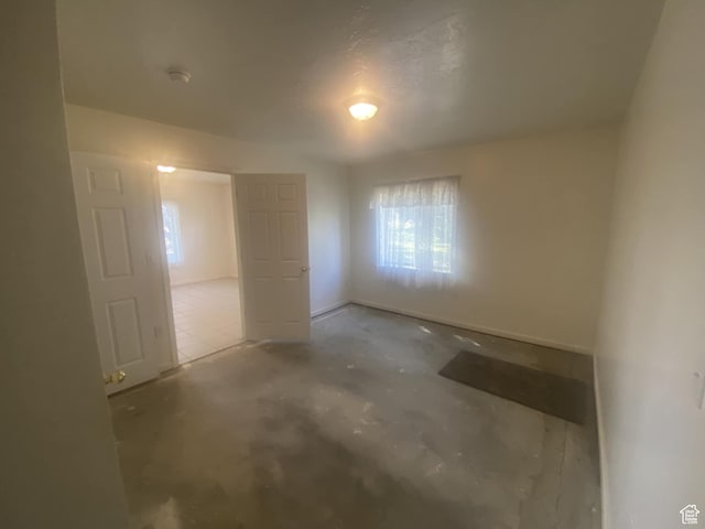 50 S 400 E, Myton, UT 84052 - unfurnished bedroom with multiple windows and concrete flooring