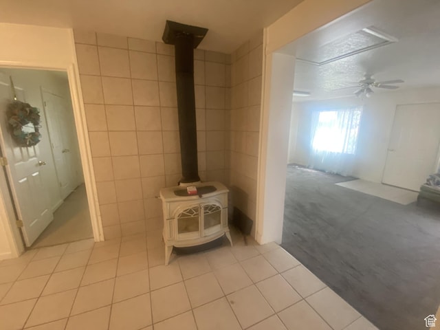 50 S 400 E, Myton, UT 84052 - detailed view of a wood stove, tile walls, carpet, and a ceiling fan