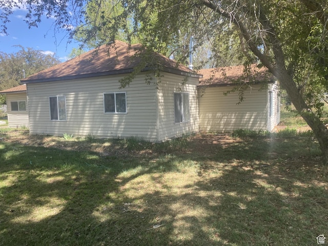 50 S 400 E, Myton, UT 84052 - view of property exterior featuring a lawn and a shingled roof