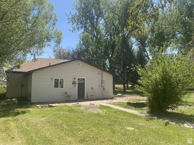 50 S 400 E, Myton, UT 84052 - rear view of property featuring a lawn and a shingled roof