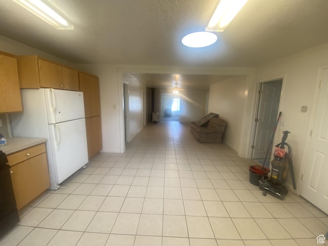 50 S 400 E, Myton, UT 84052 - kitchen with light countertops, freestanding refrigerator, and light tile patterned floors
