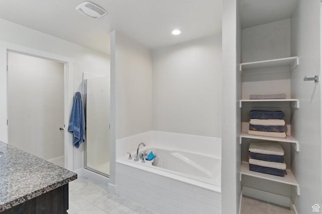 bathroom with a stall shower, a garden tub, tile patterned flooring, vanity, and recessed lighting