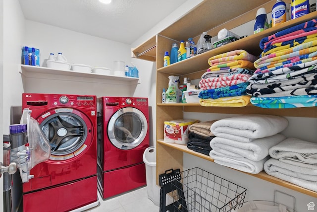 laundry area featuring independent washer and dryer and tile patterned flooring