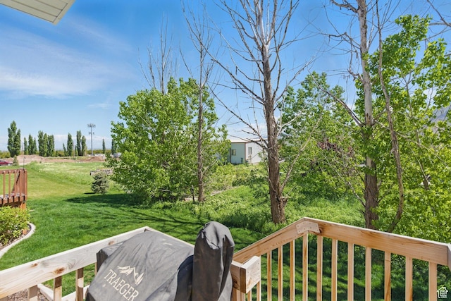 view of green lawn with a deck