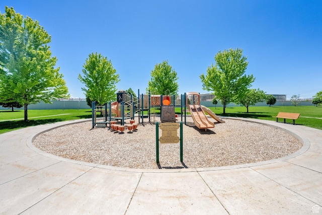 communal playground featuring a lawn