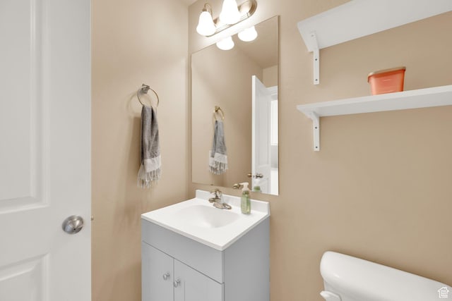 half bathroom featuring toilet and vanity