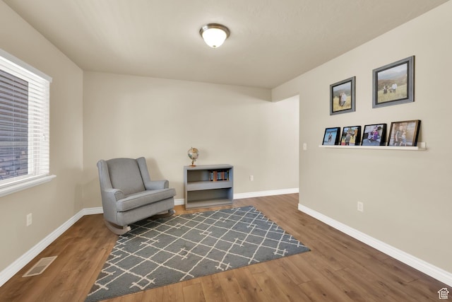 sitting room with wood finished floors and baseboards