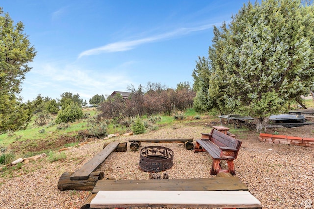 view of home's community with a fire pit