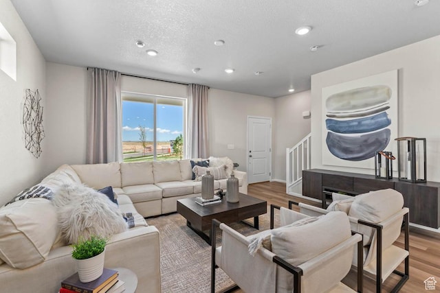 351 N Riverside Dr Unit 978, Saratoga Springs, UT 84045 - living room featuring light wood finished floors, recessed lighting, a textured ceiling, stairway, and baseboards