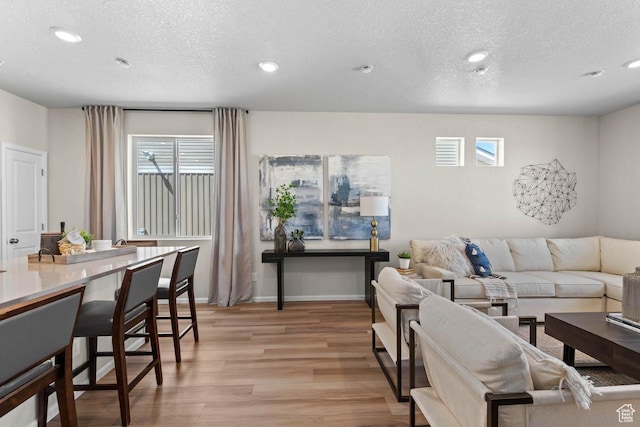 351 N Riverside Dr Unit 978, Saratoga Springs, UT 84045 - living area featuring a textured ceiling, light wood finished floors, healthy amount of natural light, and recessed lighting