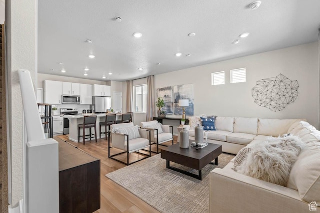 351 N Riverside Dr Unit 978, Saratoga Springs, UT 84045 - living area with healthy amount of natural light, recessed lighting, and light wood-style flooring
