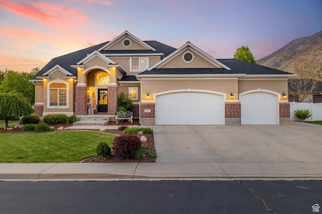512 Glendon Way, Pleasant Grove, UT 84062 - view of front of house with driveway, stucco siding, an attached garage, and brick siding